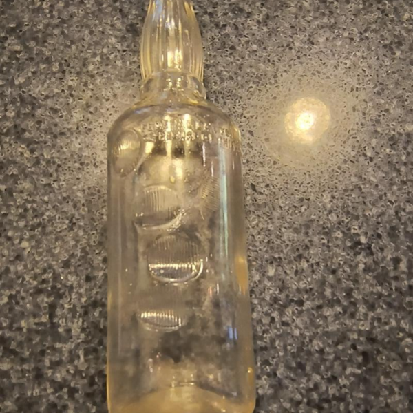 Interesting clear bottle with hand imprint in glass