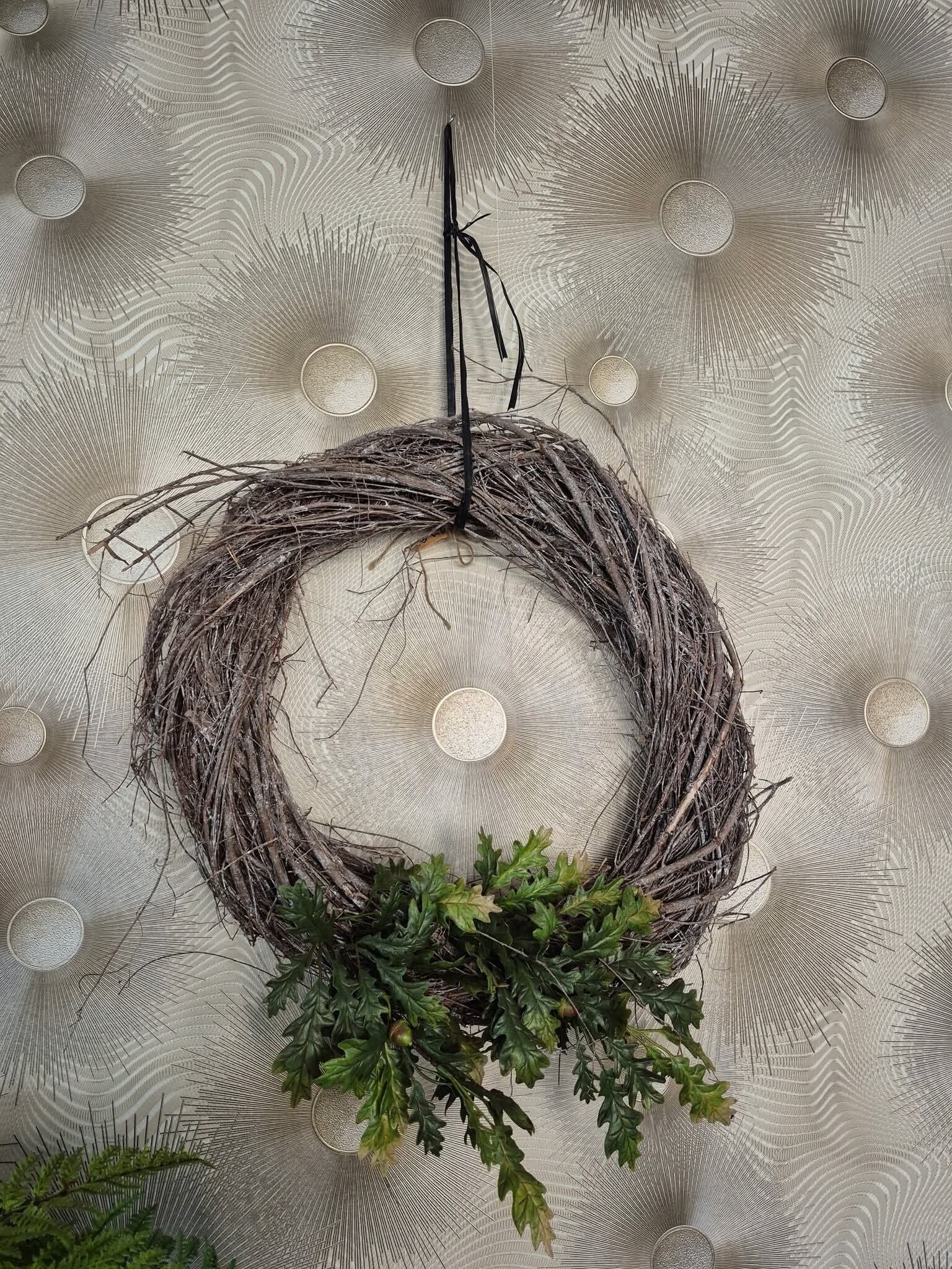 Takkenkrans versierd net eikenbladeren