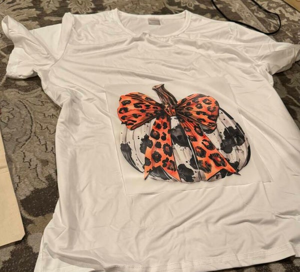 White Pumpkin with Black Spots and an Orange Bow Shirt