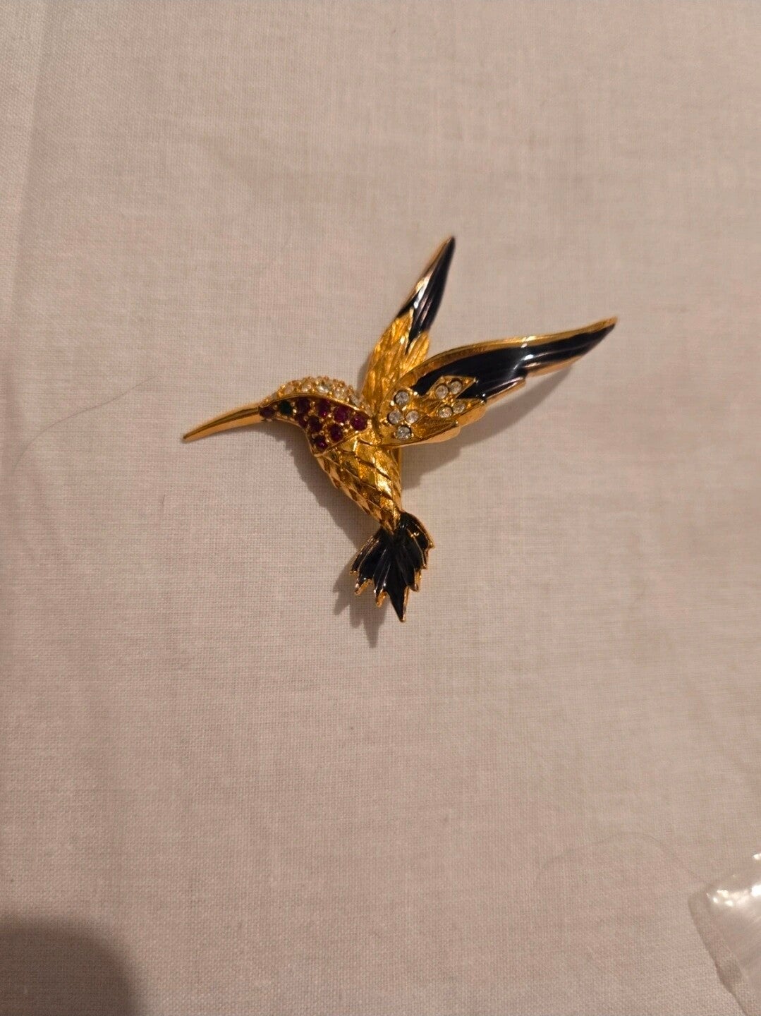 This is a vintage Sphinx hummingbird brooch from the 1960s or 1980s