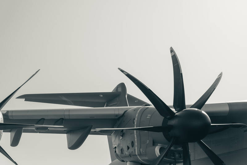 Détail d’une hélice et de l’aile d’un avion militaire de transport Airbus A400M, photographié en noir et blanc, avec un cadrage épuré et un fond clair.