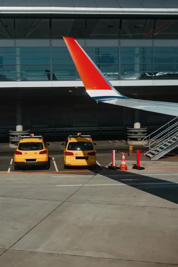 Luxury sedan waiting outside terminal for airport pickup