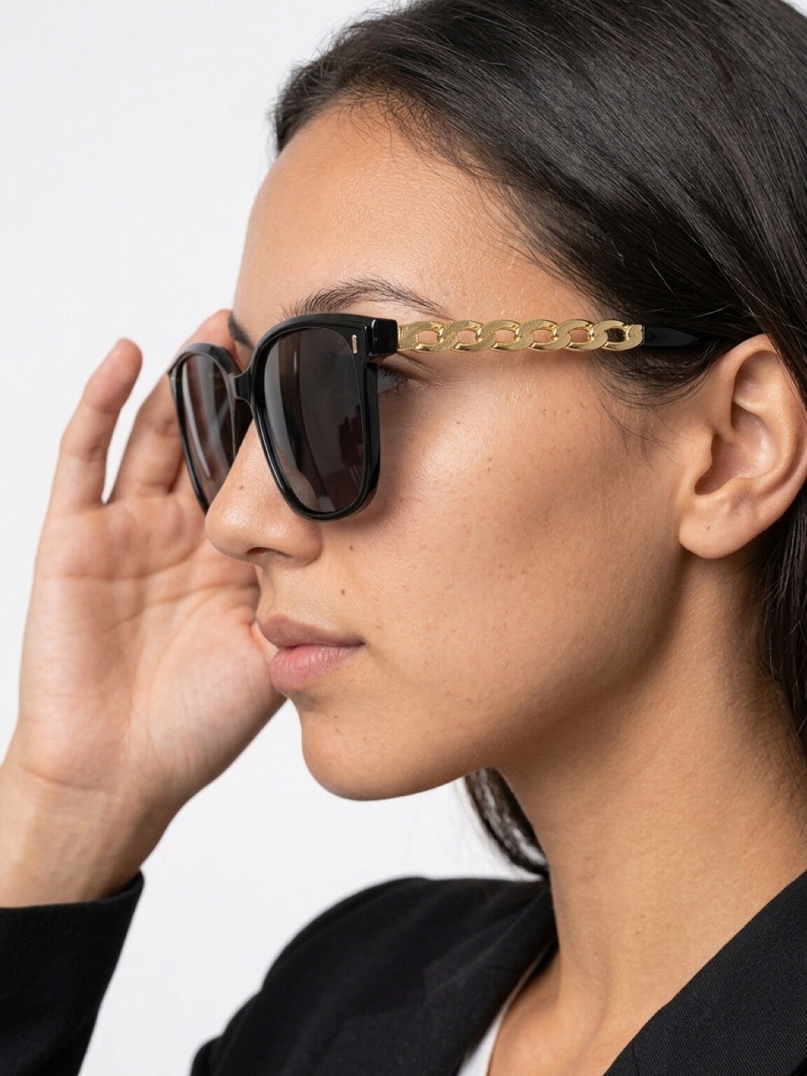 Woman wearing black and gold sunglasses