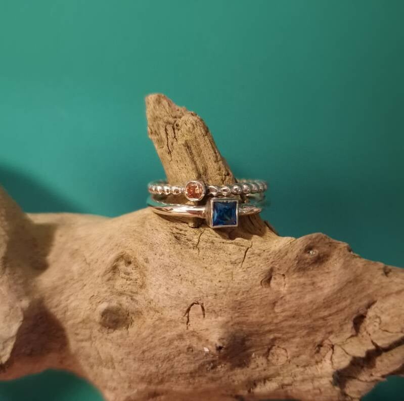 Stacking rings with yellow and blue gems