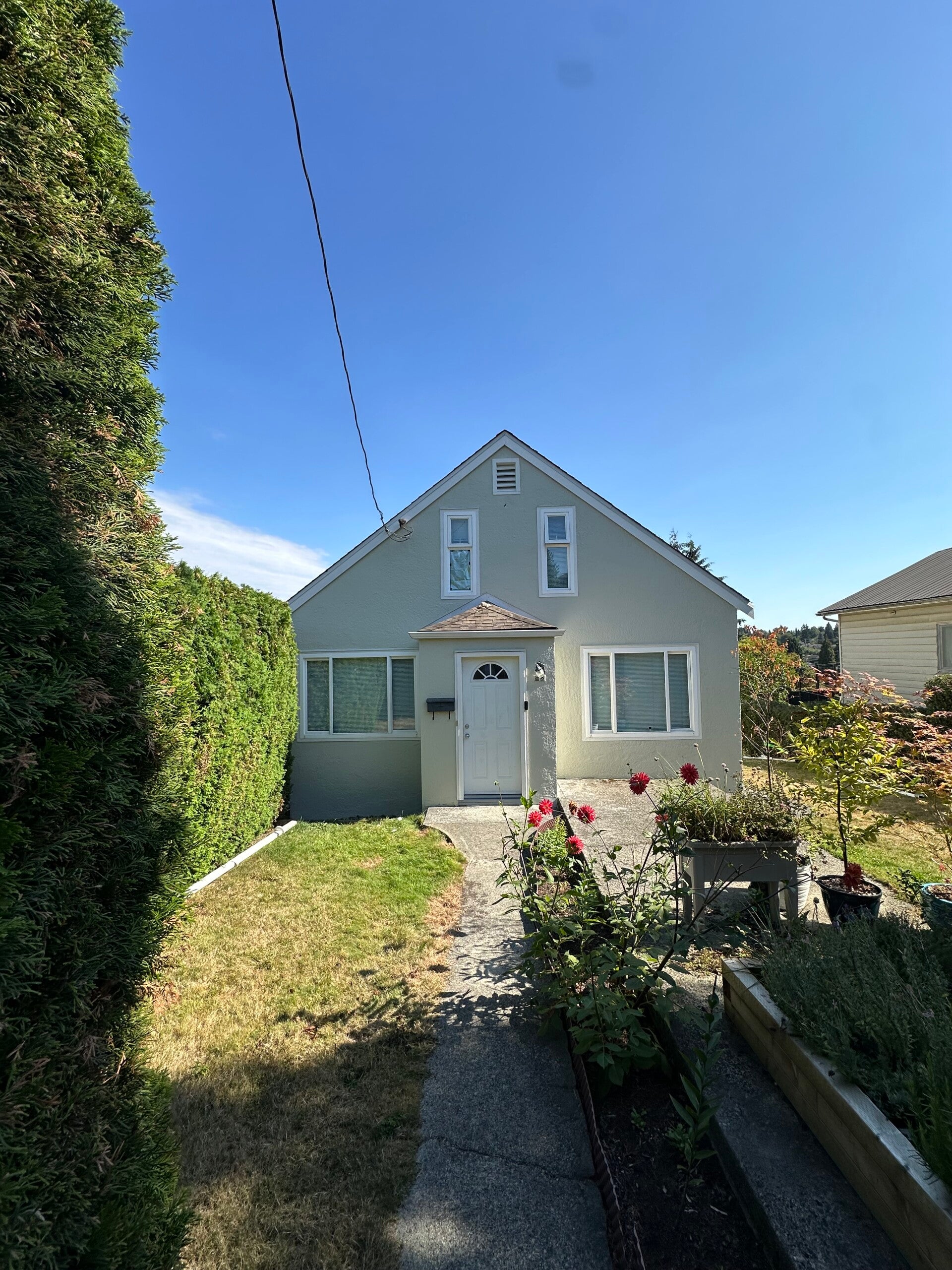 After exterior house painting in New Westminster, BC, showing a freshly painted and professionally finished residential home exterior by Tidy Brush Painting.