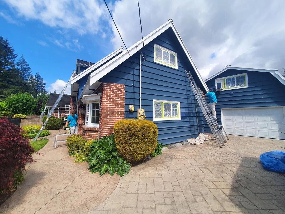 Vancouver house painters completing an exterior painting project with clean, even finishes
