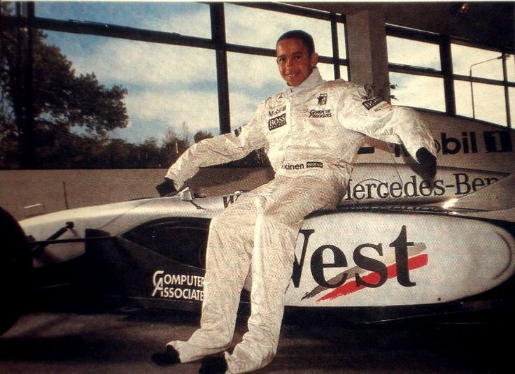 Young Lewis Hamilton in Mika Hakkinen's racesuit which is far to big for him