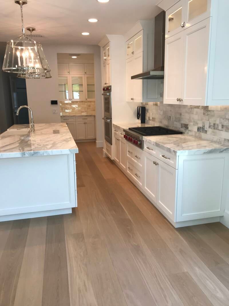 "Elegant White Oak Flooring with a sleek whitewashed finish, offering a modern, durable, and easy-to-maintain solution for creating a fresh and inviting atmosphere in any room."