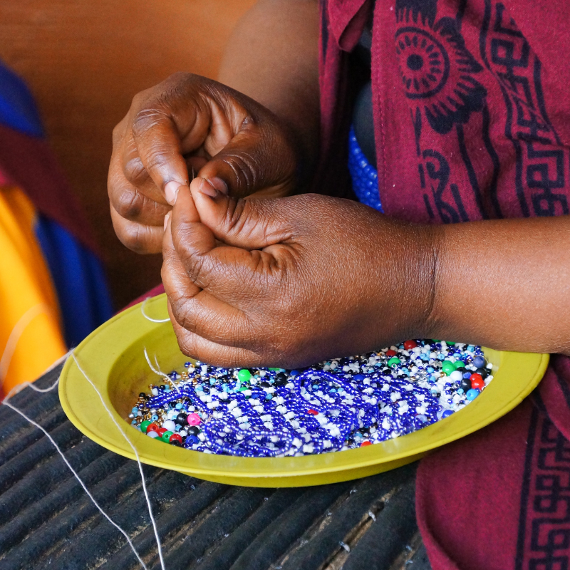 Beader making african jewellery