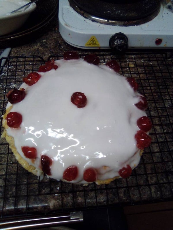 Large home made sponge with cherries on n icing