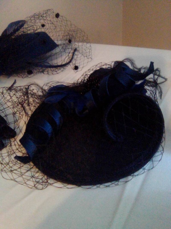 Navy fascinator with net on and a bit if royal blue ribbon on