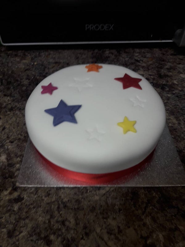 Small iced cake with stars on