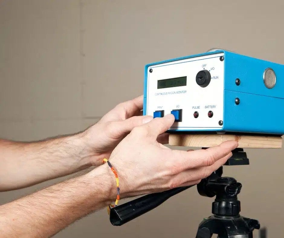 Continuous radon monitor on a tripod during a radon test in a Colorado home