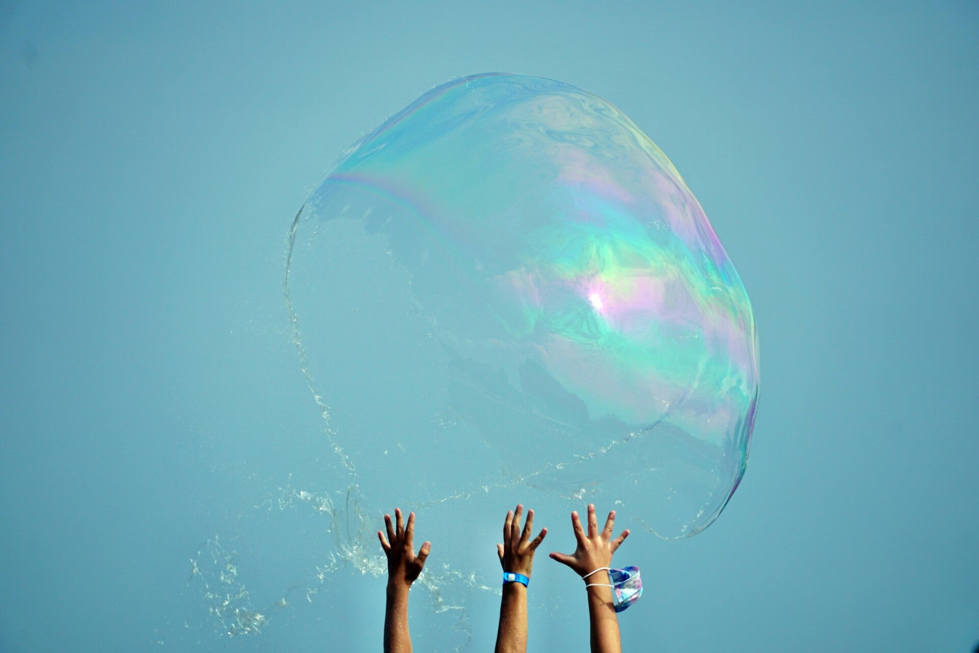 Hands that burst the bubble.