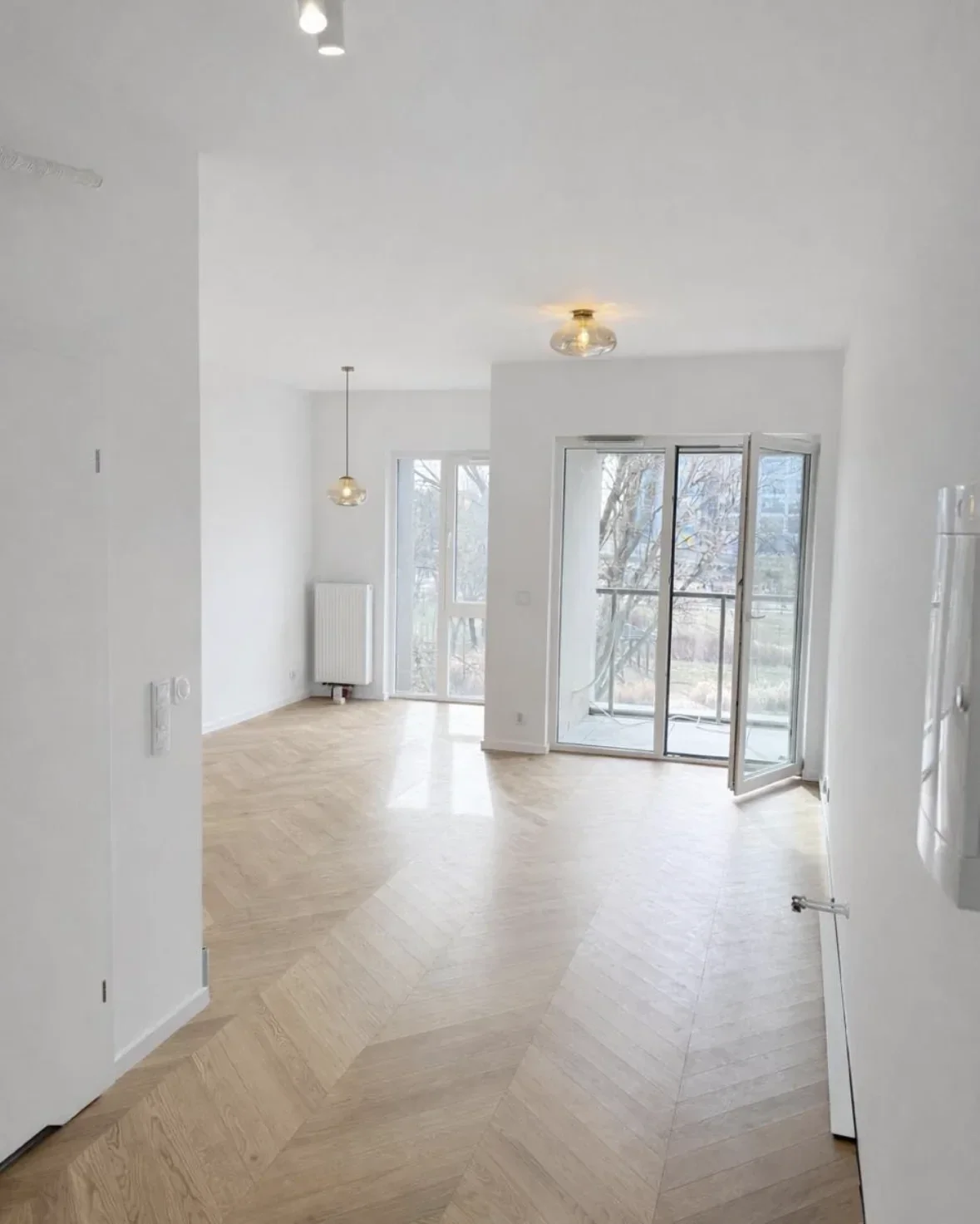 Jasny salon z podłogą w jodełkę
