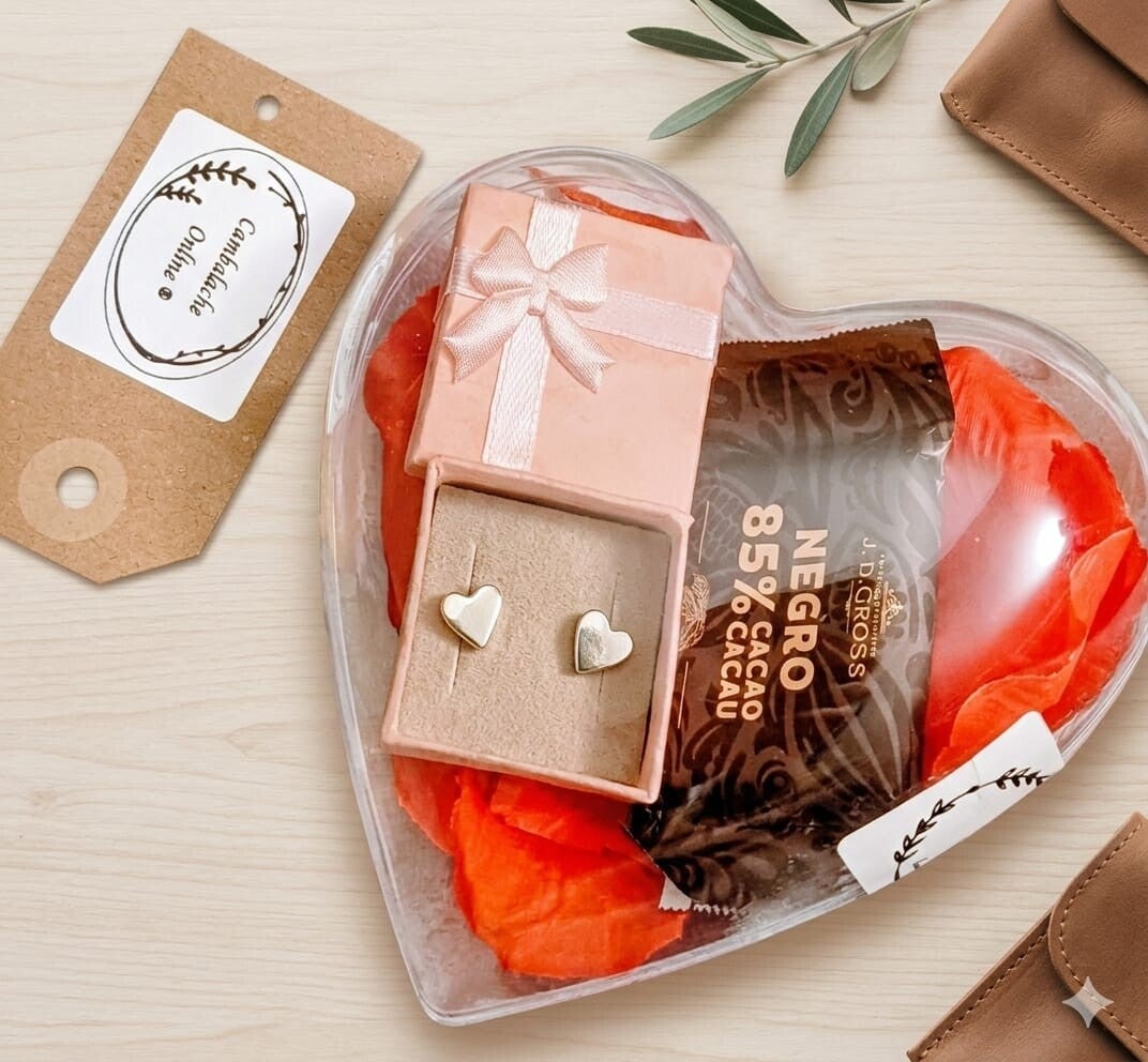 Corazón con pétalos de rosa, pendientes y un chocolate.