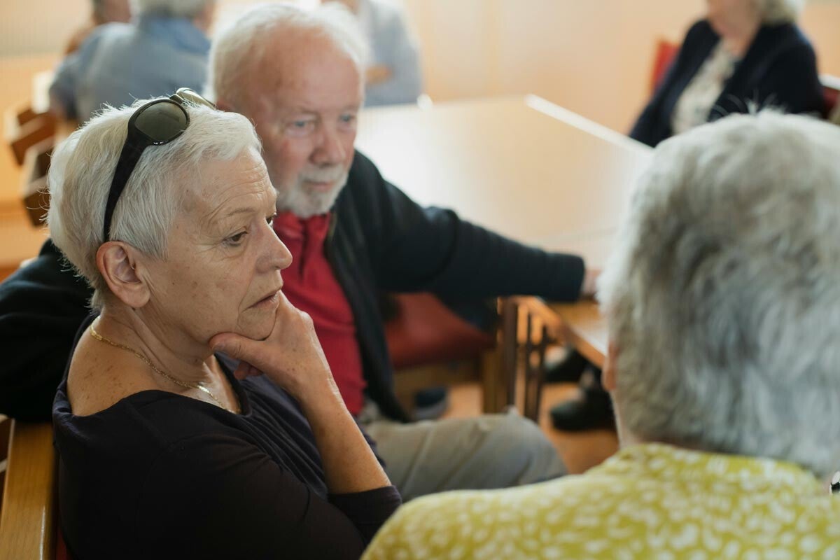 Lady with hand up at meeting
