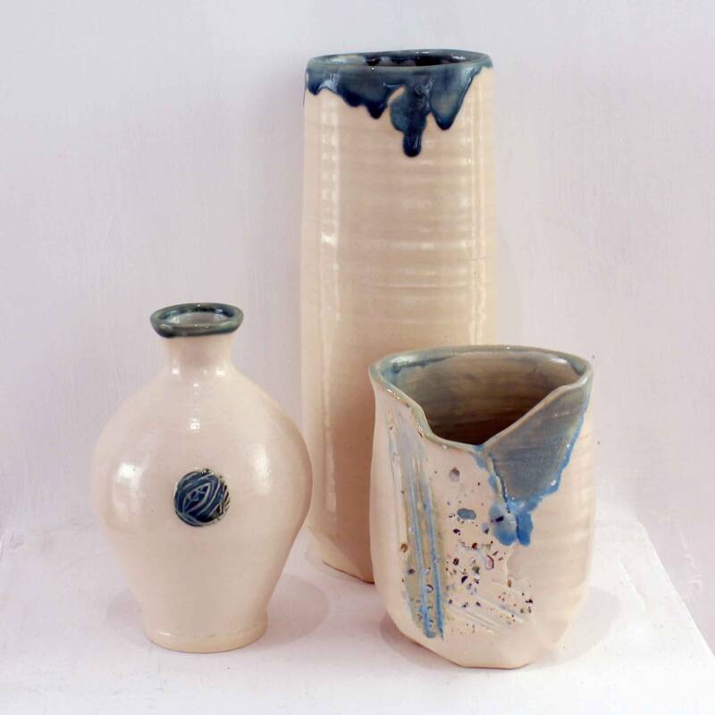 Three cream and blue ceramic vessels by Amanda Toms who grew up on the Isle of Wight