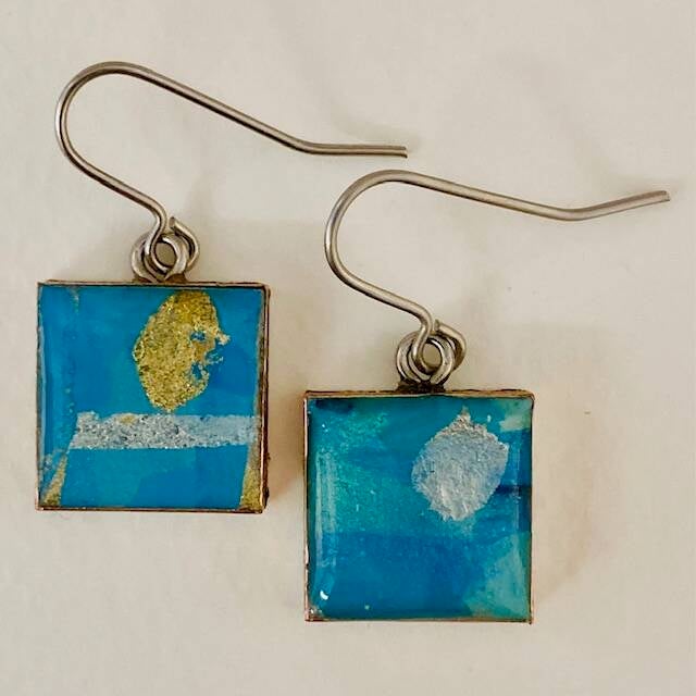 A pair of square turquoise and metal leaf drop earrings made from papier mache, silver leaf and resin by jeweller Hilary Bravo