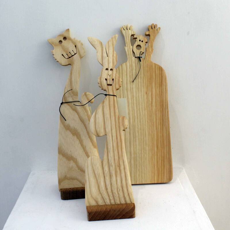 Two humorous wooden spatulas and a funny cheese board all made by Tim Foxall in his distinctive light hearted style. One spatula is cat shaped, the other based on a rabbit and the board features a quirky man with his arms in the air