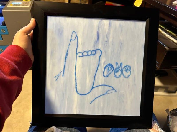Letter L ASL with baby footprint and spell love.