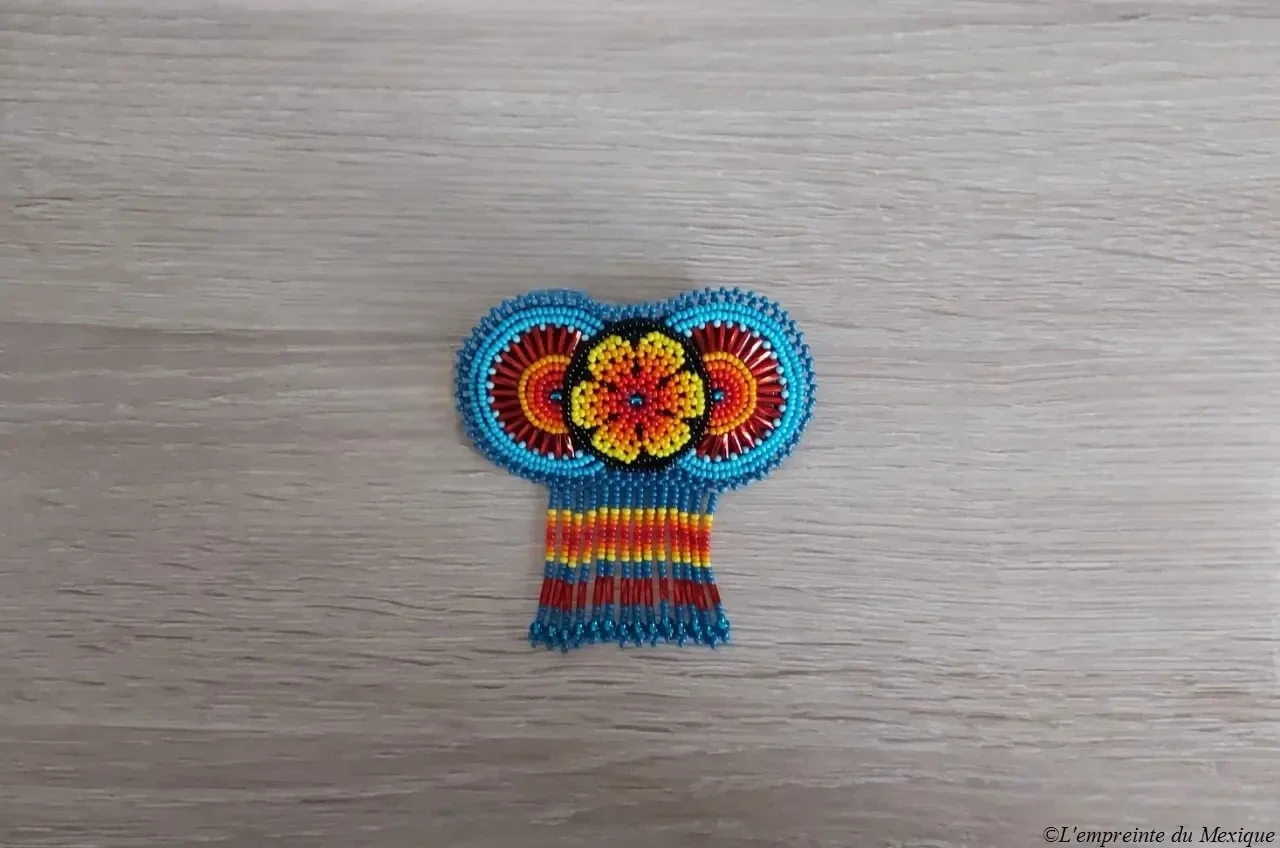 Barrette en perles de chaquiras représentant une fleur de peyotl ronde tissée à la main par Elvia Gonzalez Carrillo et sa famille, artisans de la communauté autochtone Wixarika (Huichol) à Tepic, Nayarit (Mexique)