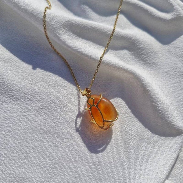 Collier en acier inoxydable doré et Cornaline en cage