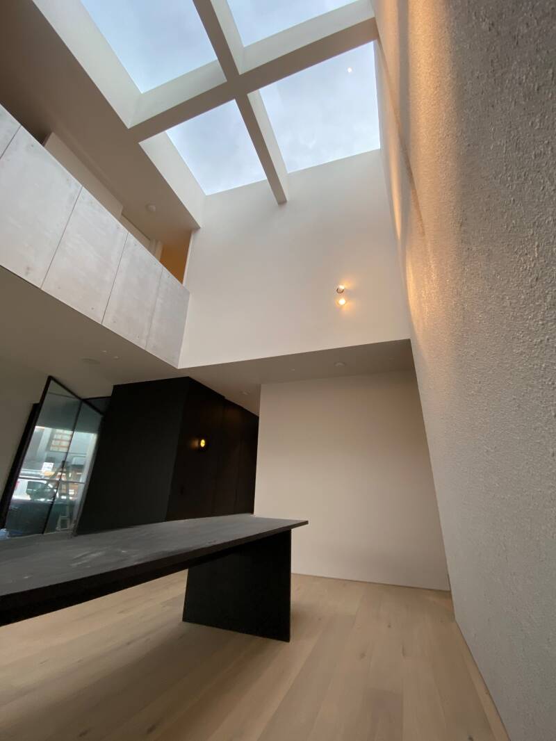 Double-height skylight void painted white, Melbourne