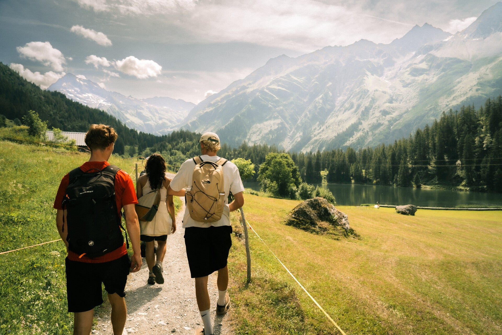 Guests on a private guided hike beside a Swiss Alpine lake