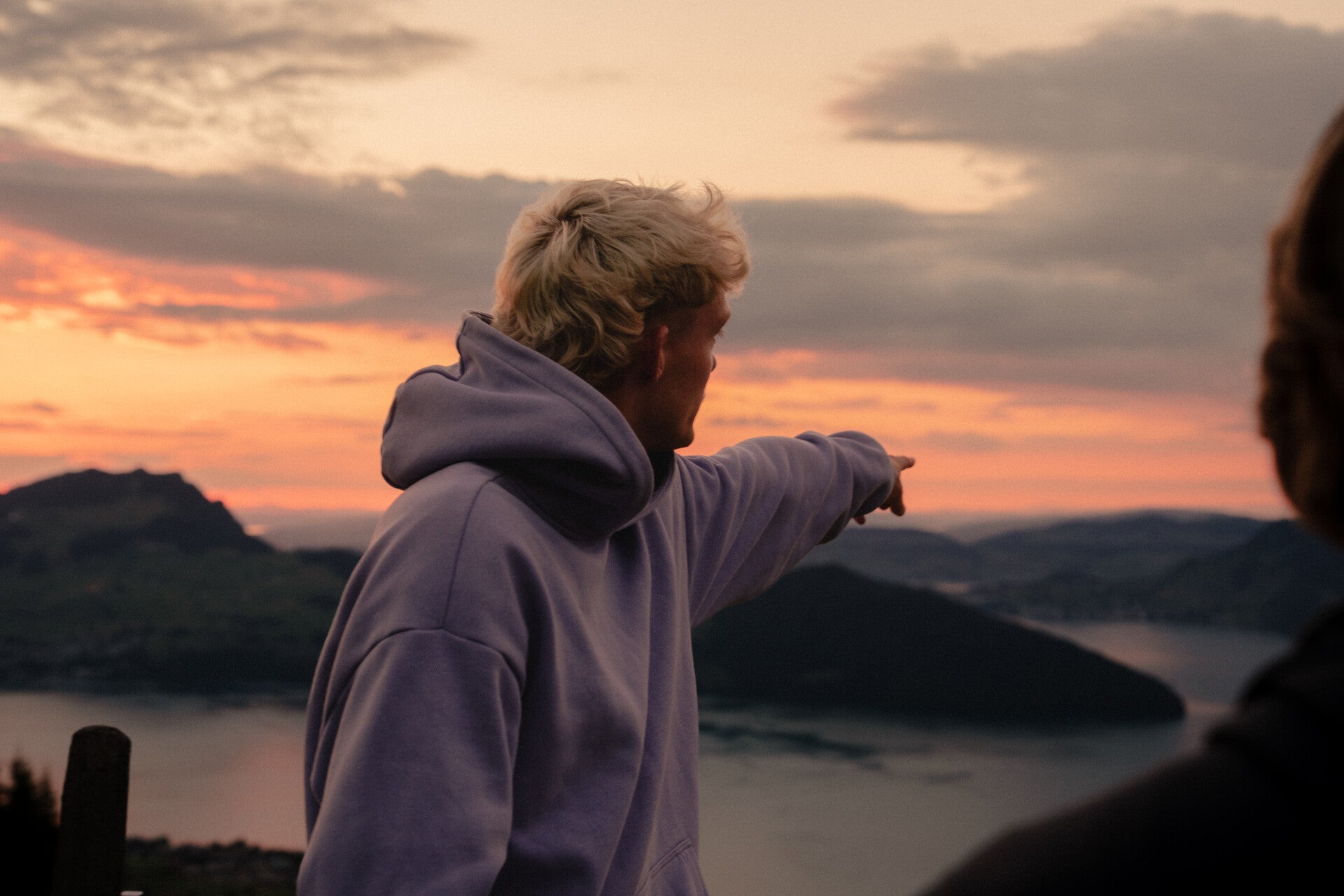 Local guide pointing out the mountain view at sunset in Central Switzerland