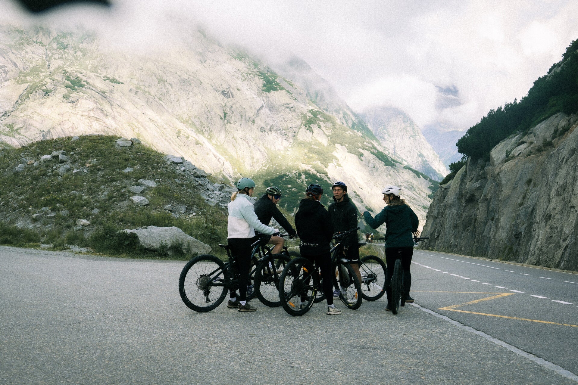 Small cycling group preparing for a guided Swiss mountain ride