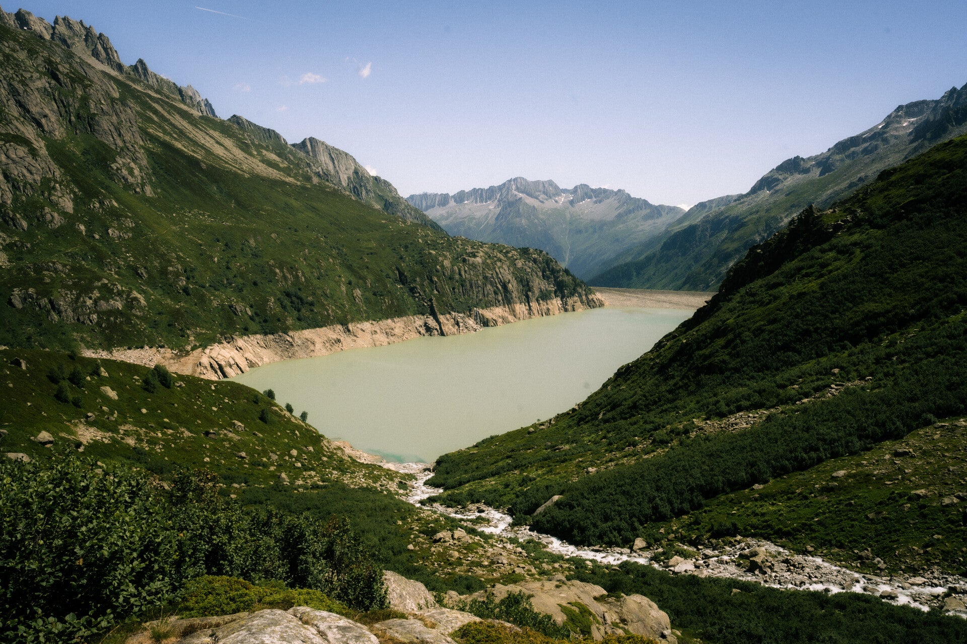 Turquoise Alpine reservoir on a private Swiss tour route
