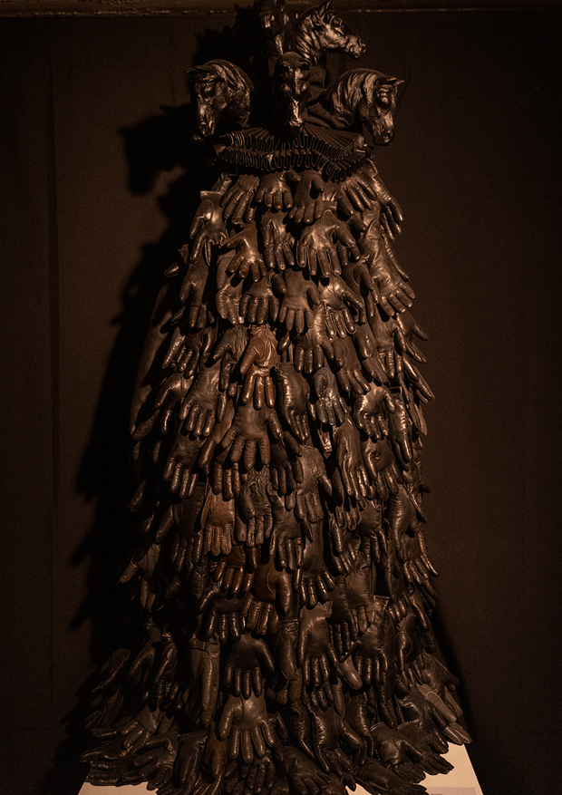 Textile object made out of horseheads, millstone collar, leather gloves. 