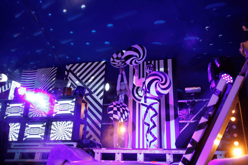 People wearing clothes with  black and white patterns on matching stage.