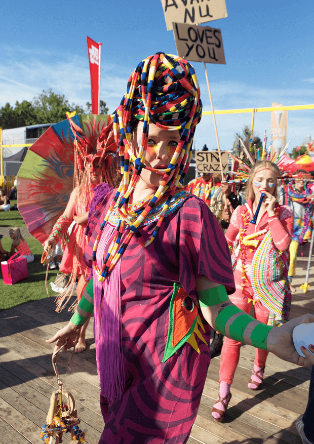 Person wearing colorful costume marching outside