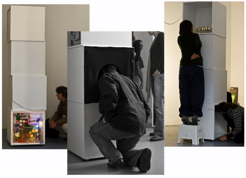 People looking in white boxes