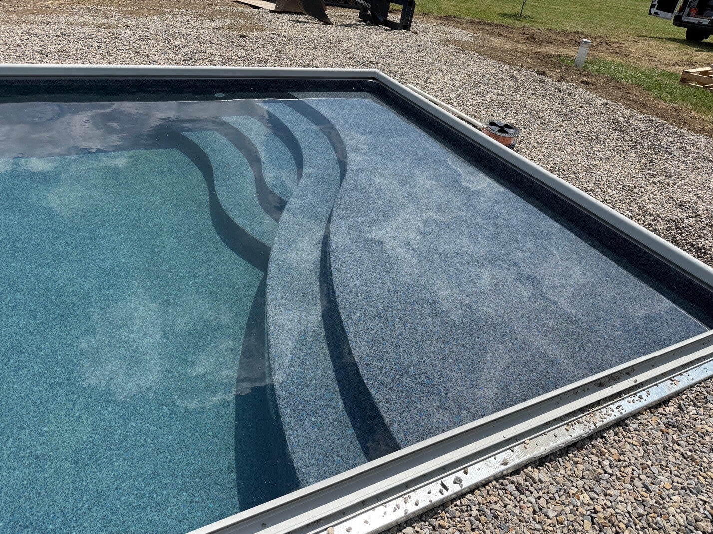 Custom curved entry steps in a Rainbow Pools vinyl liner installation
