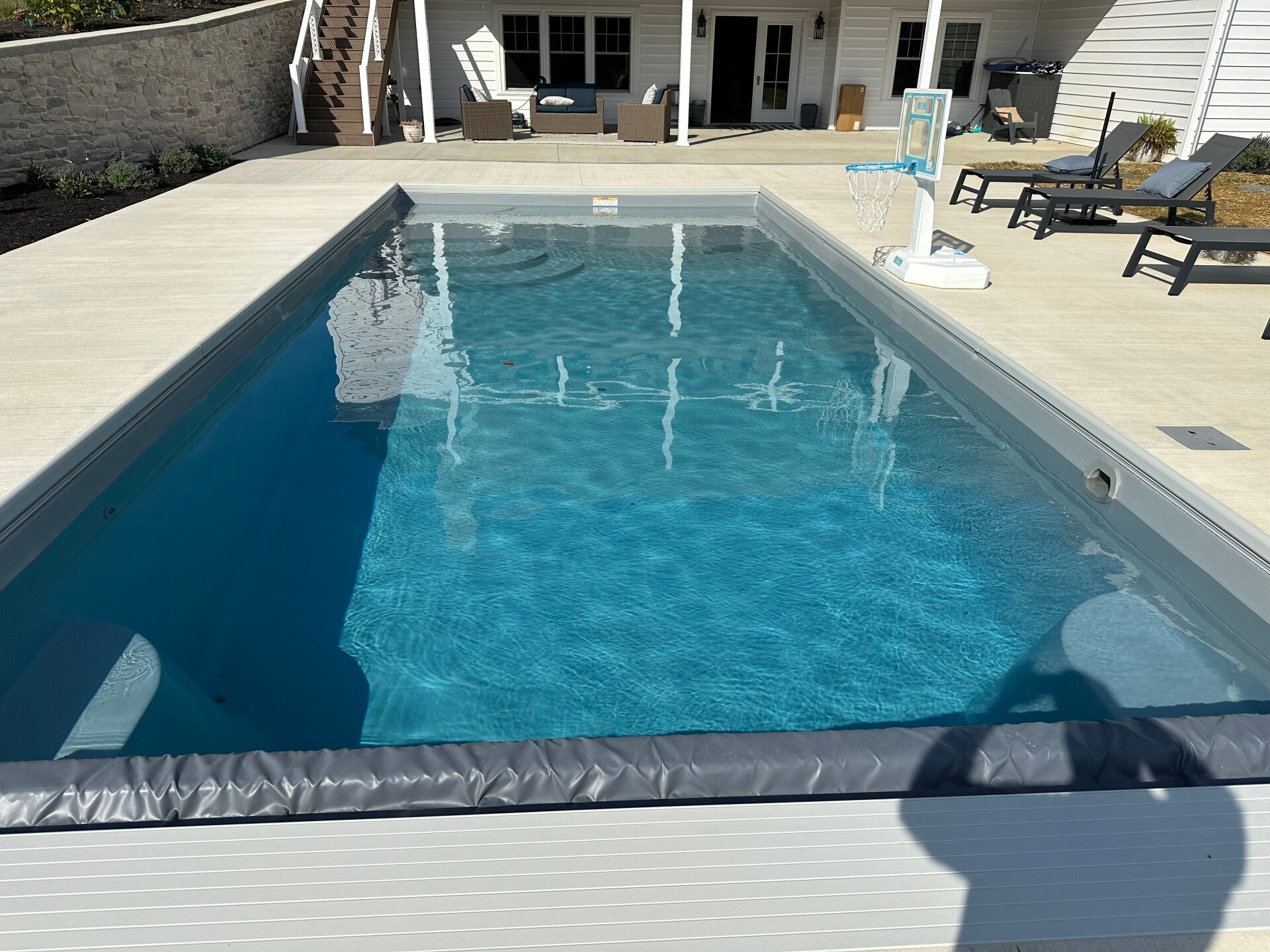 A closer view of the water, entry, and surrounding patio.