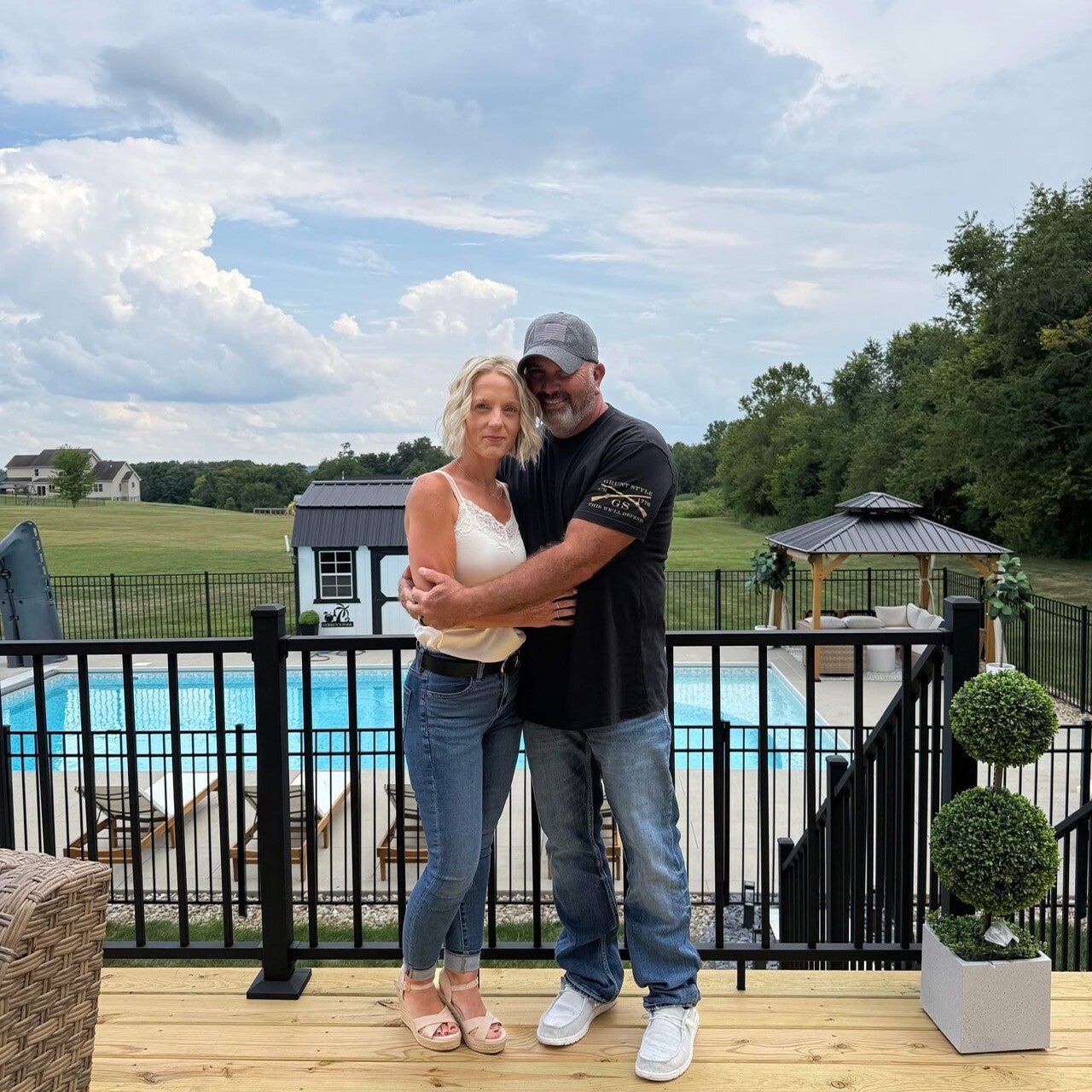 James and Amber beside a backyard pool