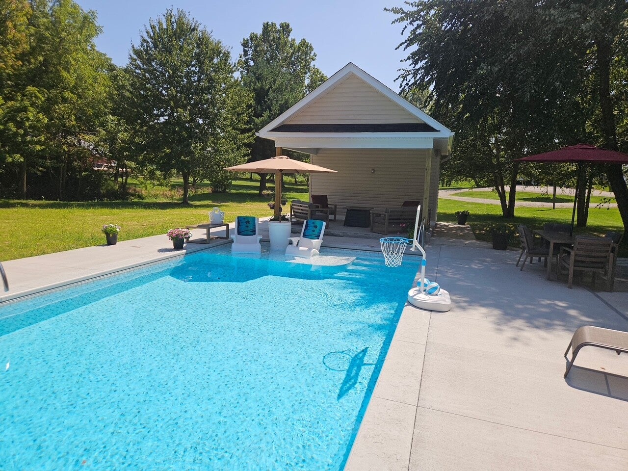 Rainbow Pools custom vinyl liner installation with a sun deck, entry steps, and in-water loungers