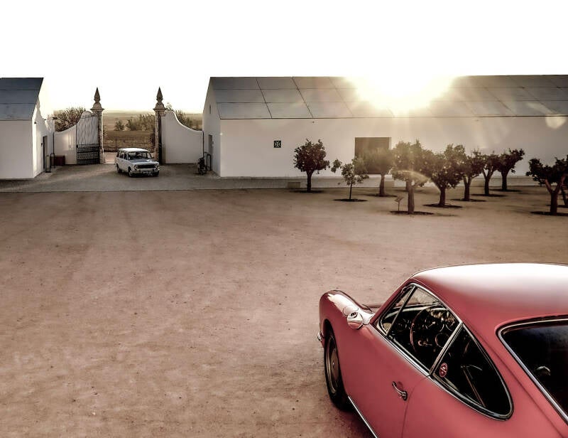 Street photography Alentejo, Portugal: friendly bullfight allegory between Porsche and Fiat