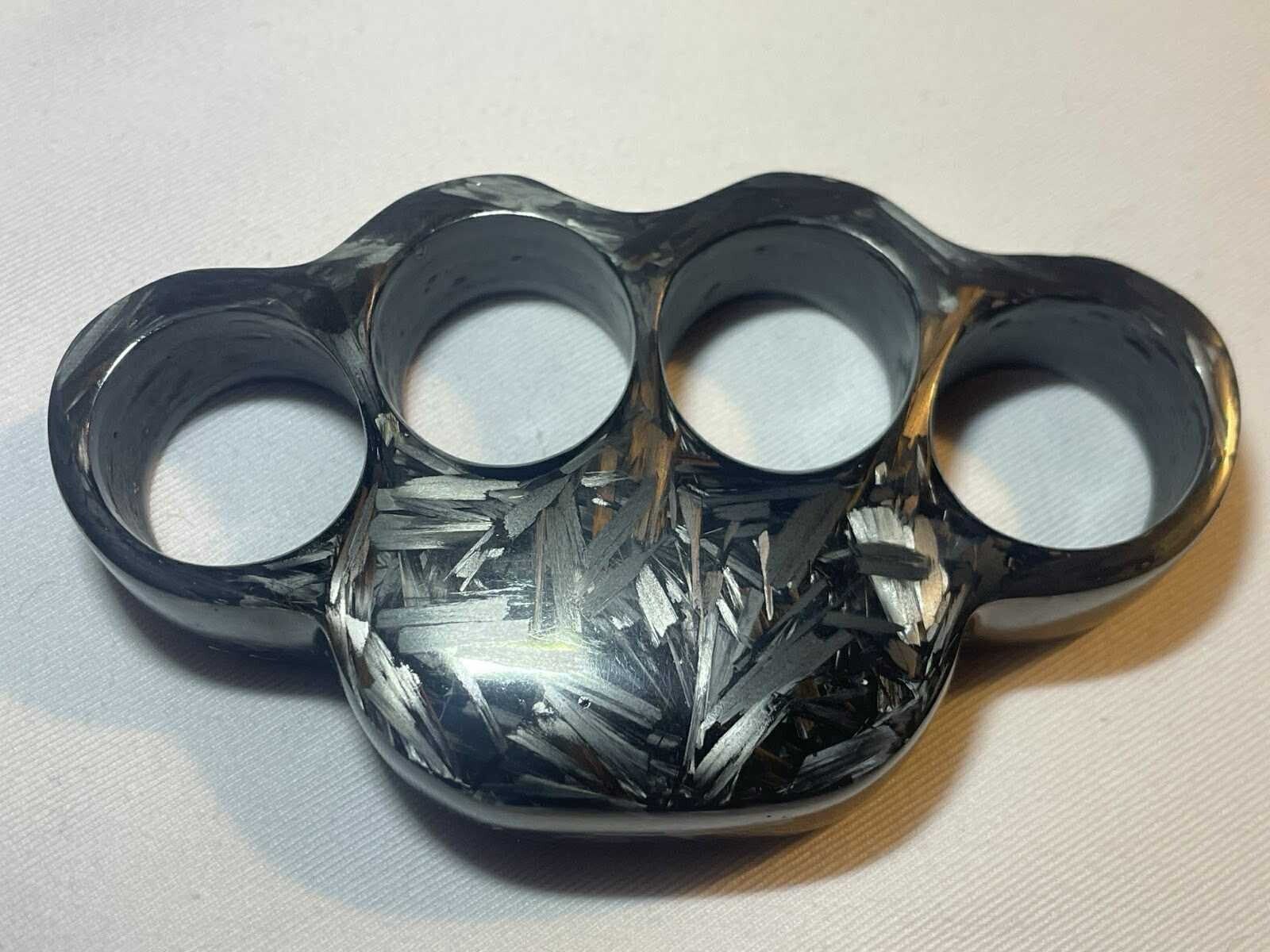 Handcrafted forged carbon fiber knuckles from Sweden  Close up detail of carbon fiber knuckle weave  Collector display of carbon fiber knuckles
