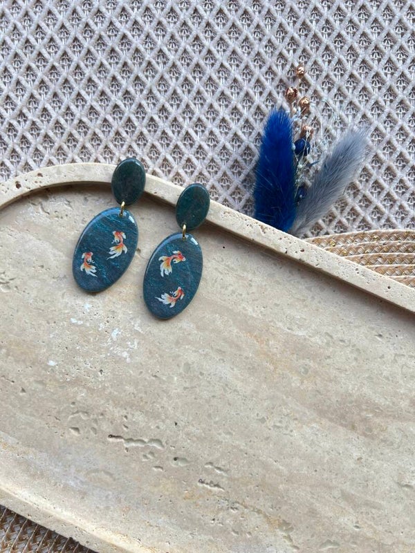 Statement oorbellen koi