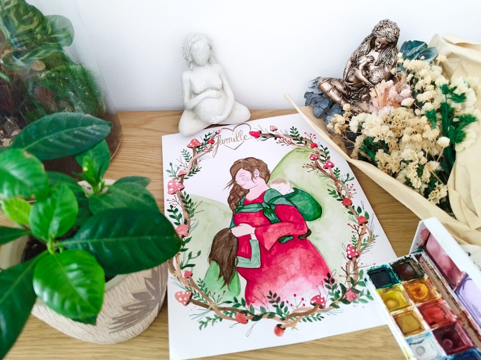 illustration aquarelle d'une famille aman grossesse et portage bébé et enfant chmpignon en cadre et branche coeur plante