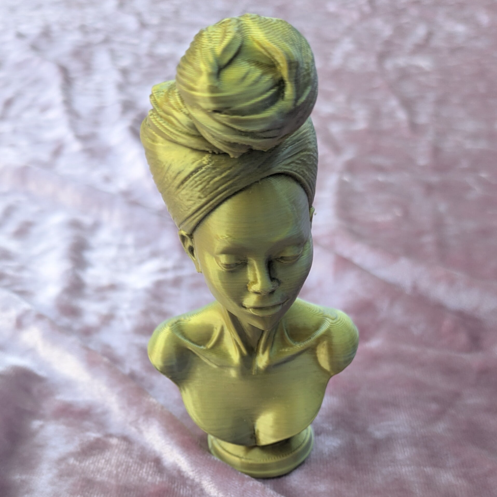 Sculpture of Woman Wearing Headwrap in Gold