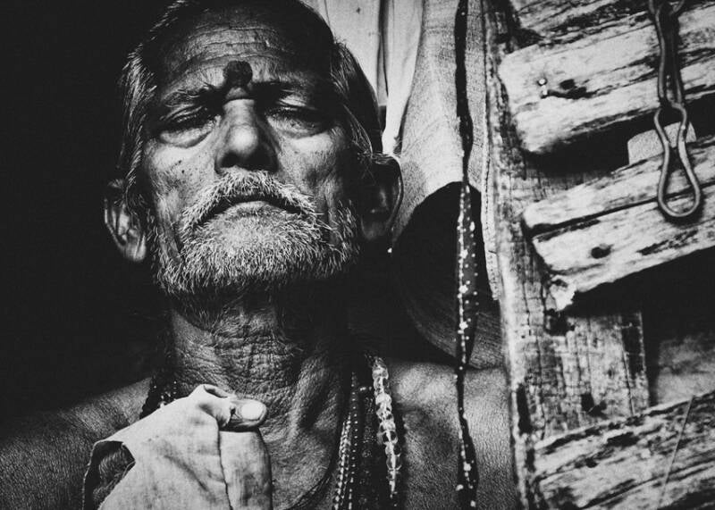 Man with praying with closed eyes
