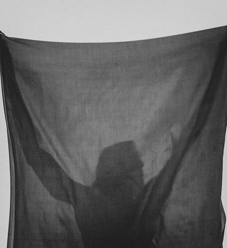 Silhouette of man behind a cloth