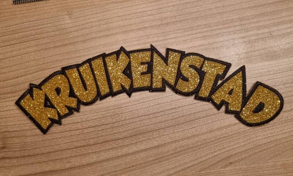 Rug embleem Kruikenstad goud glitter