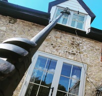 Using a Water Fed Pole system to clean first-floor windows on a residential property in Telford – Bright Starz delivering eco-friendly, streak-free results.