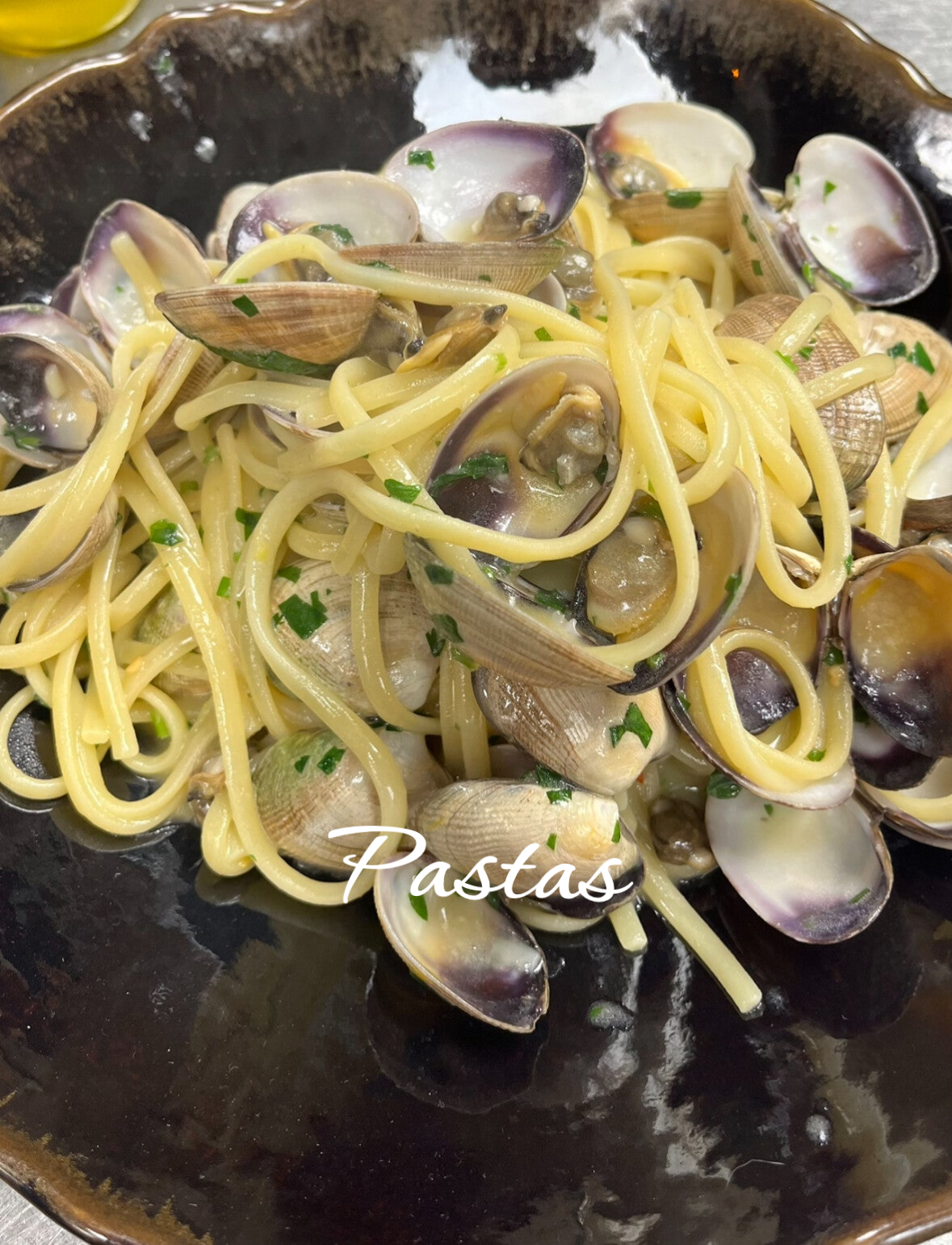 Premium Italian linguine with fresh clams and seafood reduction, high-end private chef pasta experience.